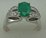 10 Karat White Gold Diamond Shoulder Ring with Oval Shaped Emerald